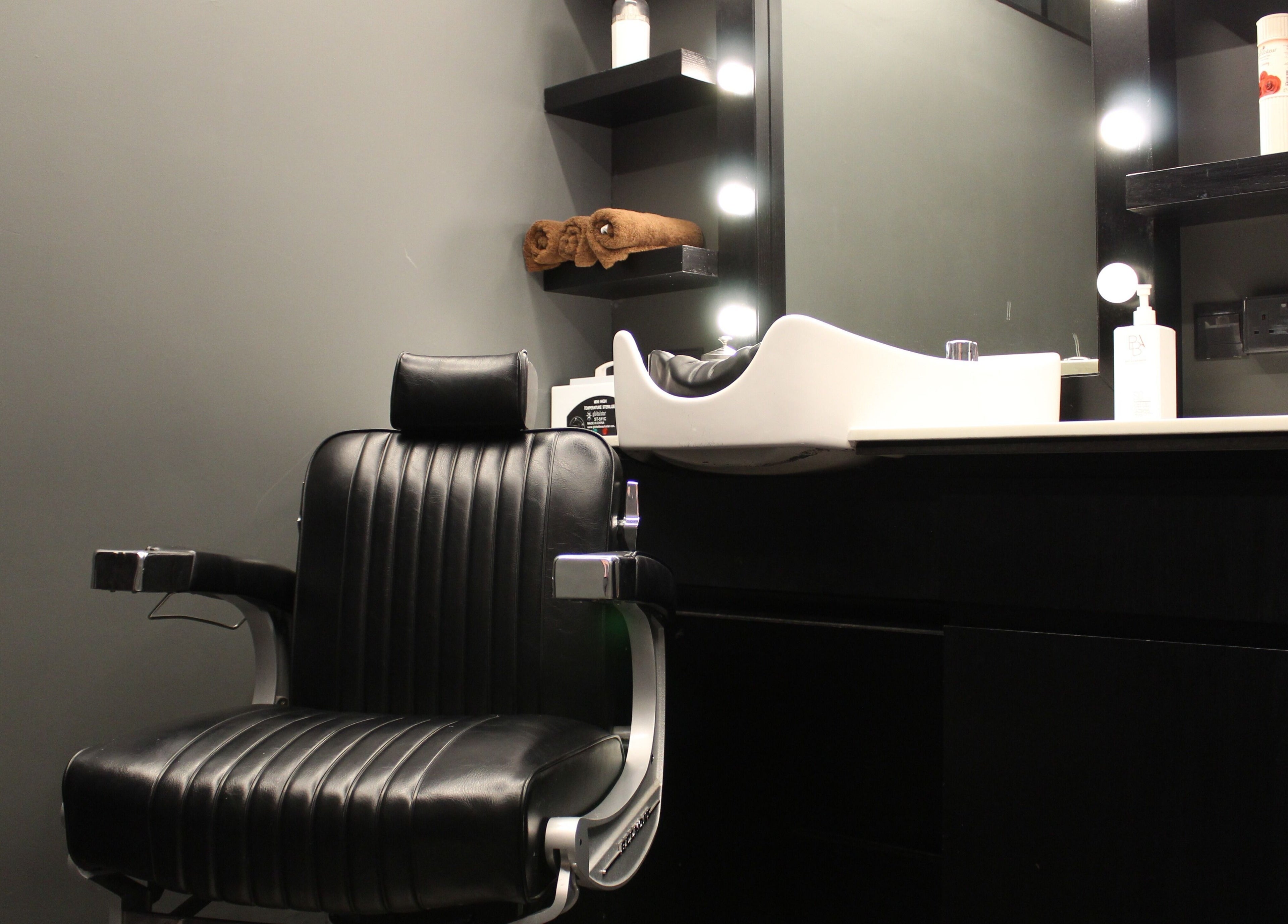 Modern barber chair and sink at Musk Barbershop JVC, Dubai, Dubai, AE, offering a premium grooming experience.