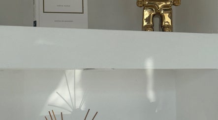 Stylish shelf with a golden ornament at BellaBonds Hair Extensions, Tynemouth, England, GB.