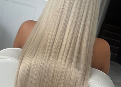 Long silky blonde hair extension at BellaBonds Hair Extensions, Tynemouth, England, GB, showcasing sleek elegance.