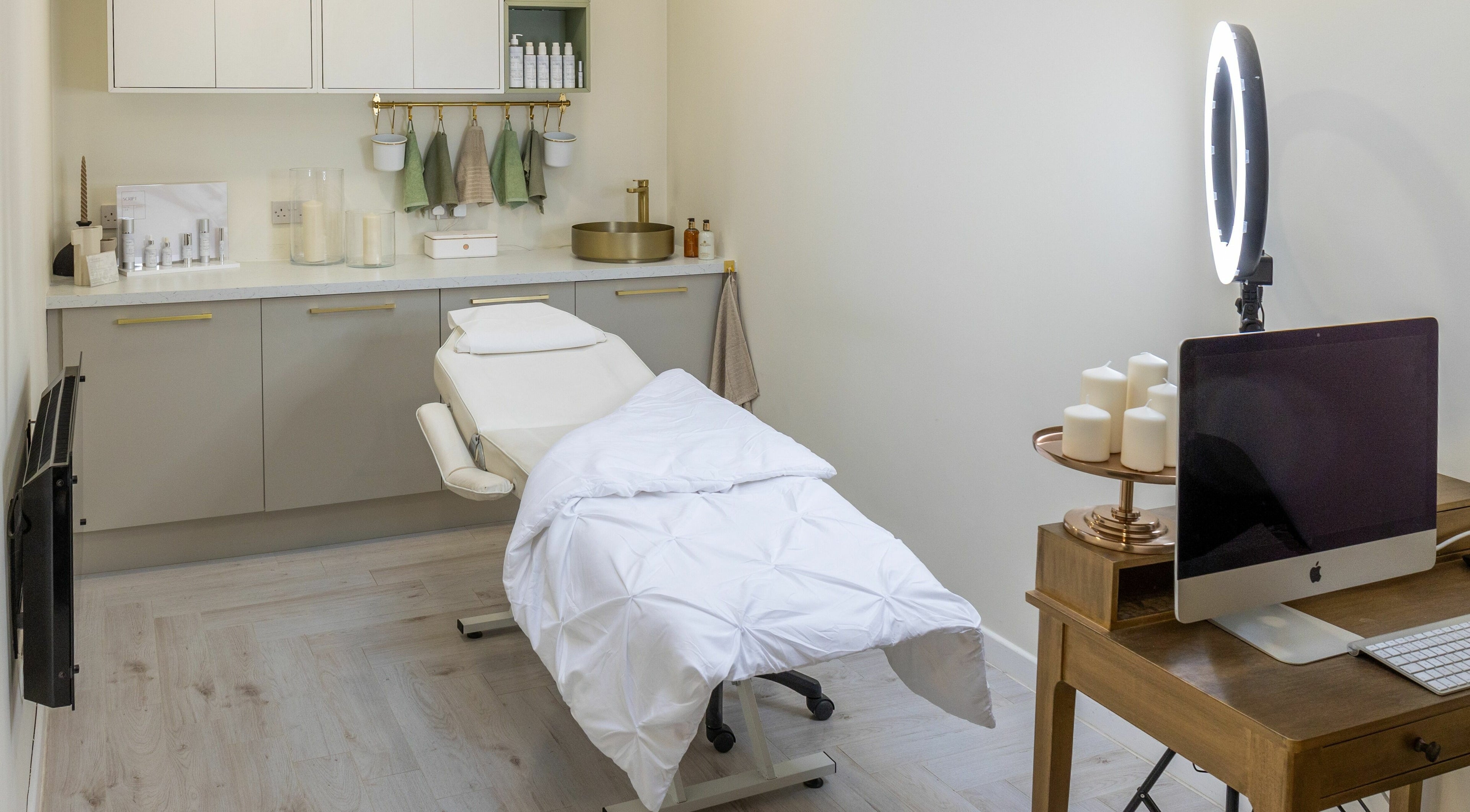 Emma at Hamilton Clinic's serene treatment room in Hamilton, GB, with a comfortable spa bed and soothing decor.