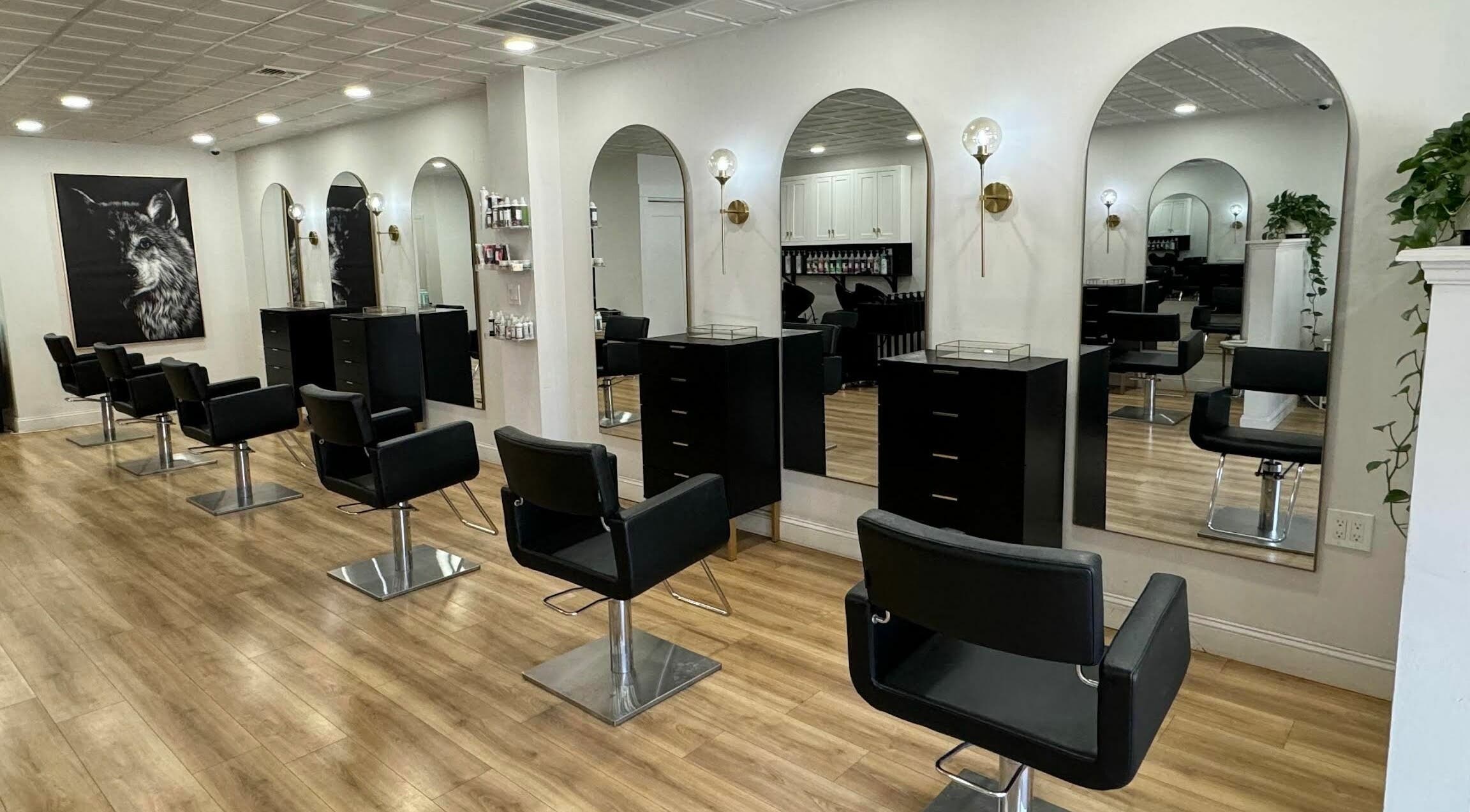Modern salon interior with mirrors at Isla and Wolf Beauty in Saint James, New York, US.