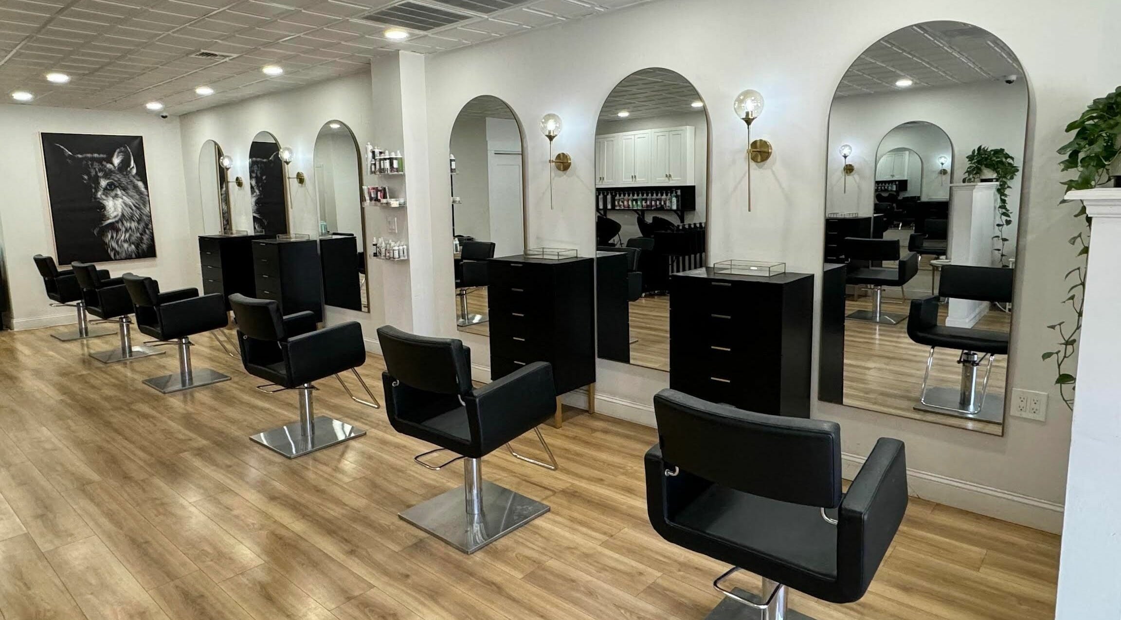 Modern salon interior with mirrors at Isla and Wolf Beauty in Saint James, New York, US.