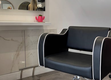 Sleek black styling chair at Emily Sinclair Hair, Congleton, England, GB, enhancing modern salon elegance.