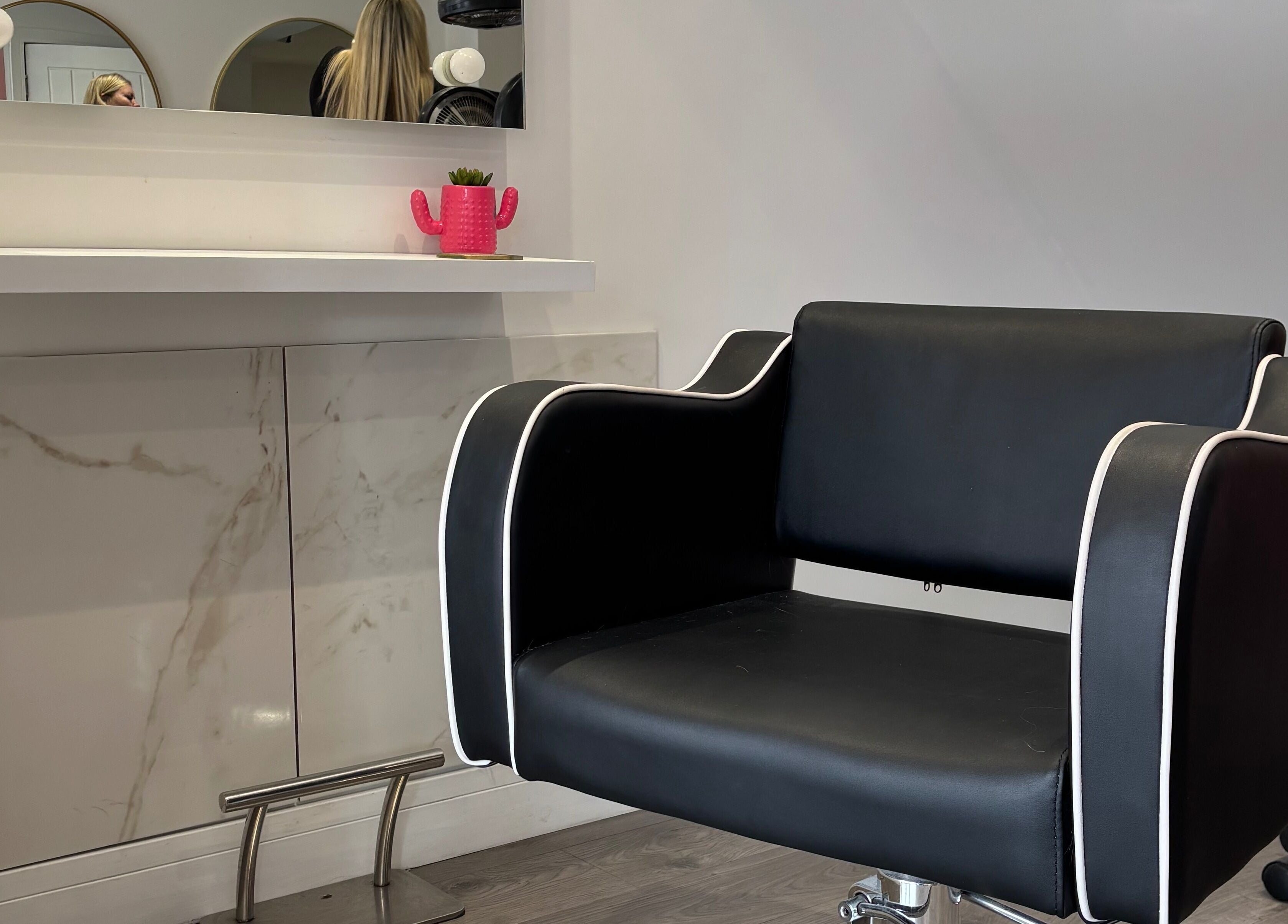Sleek black styling chair at Emily Sinclair Hair, Congleton, England, GB, enhancing modern salon elegance.