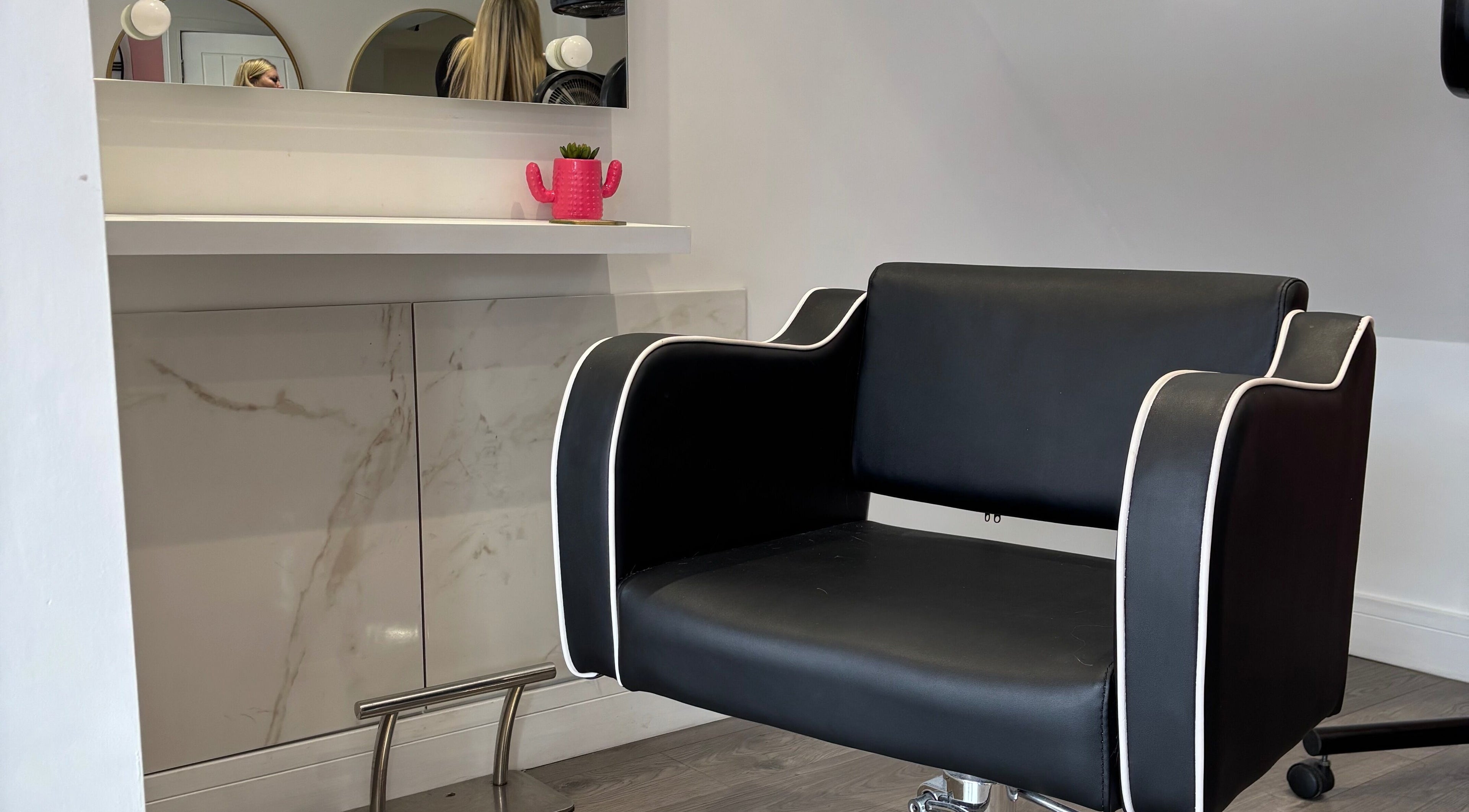 Sleek black styling chair at Emily Sinclair Hair, Congleton, England, GB, enhancing modern salon elegance.