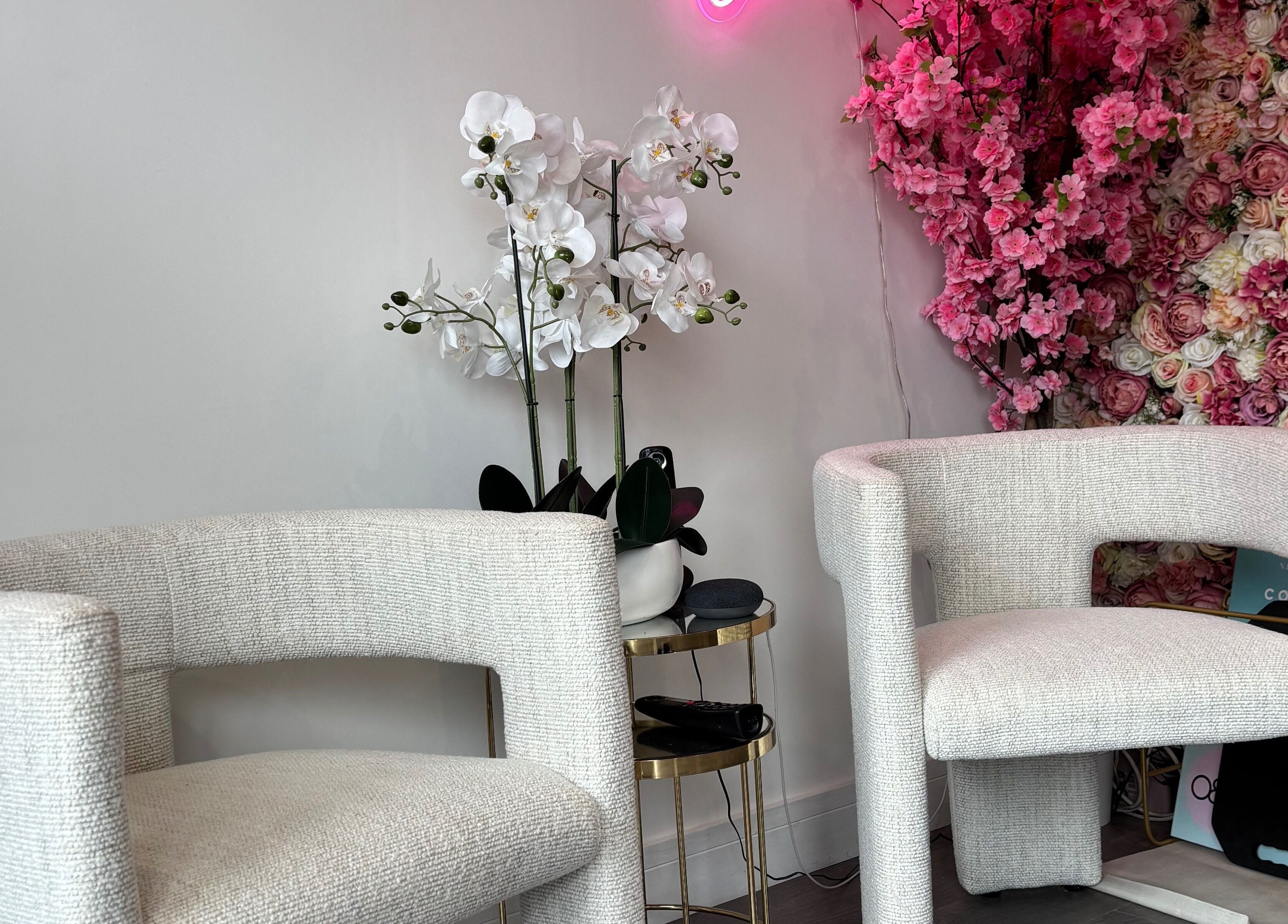 Elegant seating with floral backdrop at Emily Sinclair Hair, Congleton, England, GB.