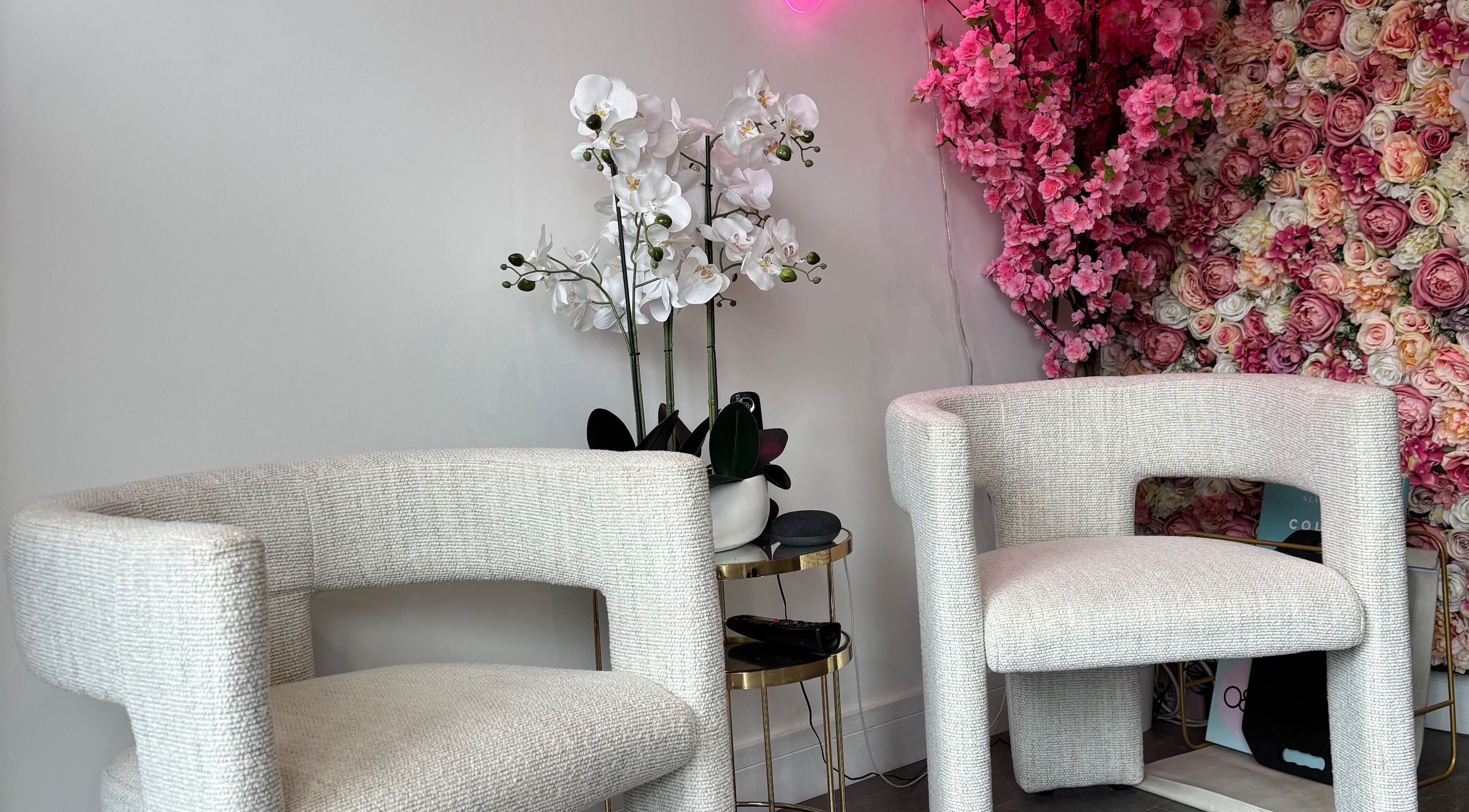 Elegant seating with floral backdrop at Emily Sinclair Hair, Congleton, England, GB.
