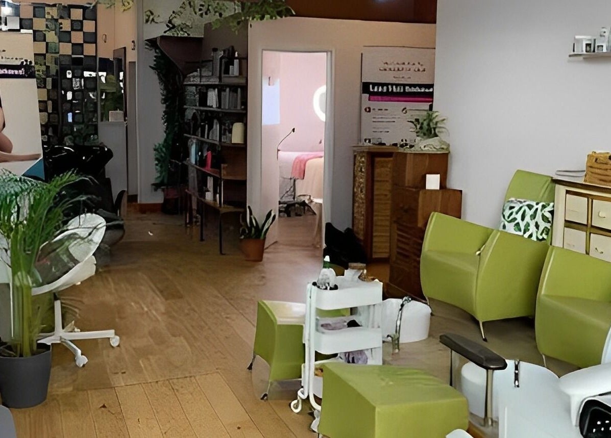 Welcoming interior of Lash by Daria in London, England, GB. Modern chairs and plants create a serene ambiance.