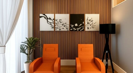 Modern lounge with orange chairs at @ Relax Union Square, Melbourne, Victoria, AU.