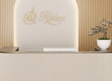 Elegant reception at @ Relax Union Square, Melbourne, Victoria, AU, with wood panel walls and potted plant.