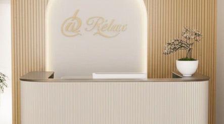 Elegant reception at @ Relax Union Square, Melbourne, Victoria, AU, with wood panel walls and potted plant.