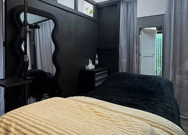 Cozy treatment room at StudioEDIT in Kawakawa, Northland, NZ featuring plush bedding and relaxing ambiance.