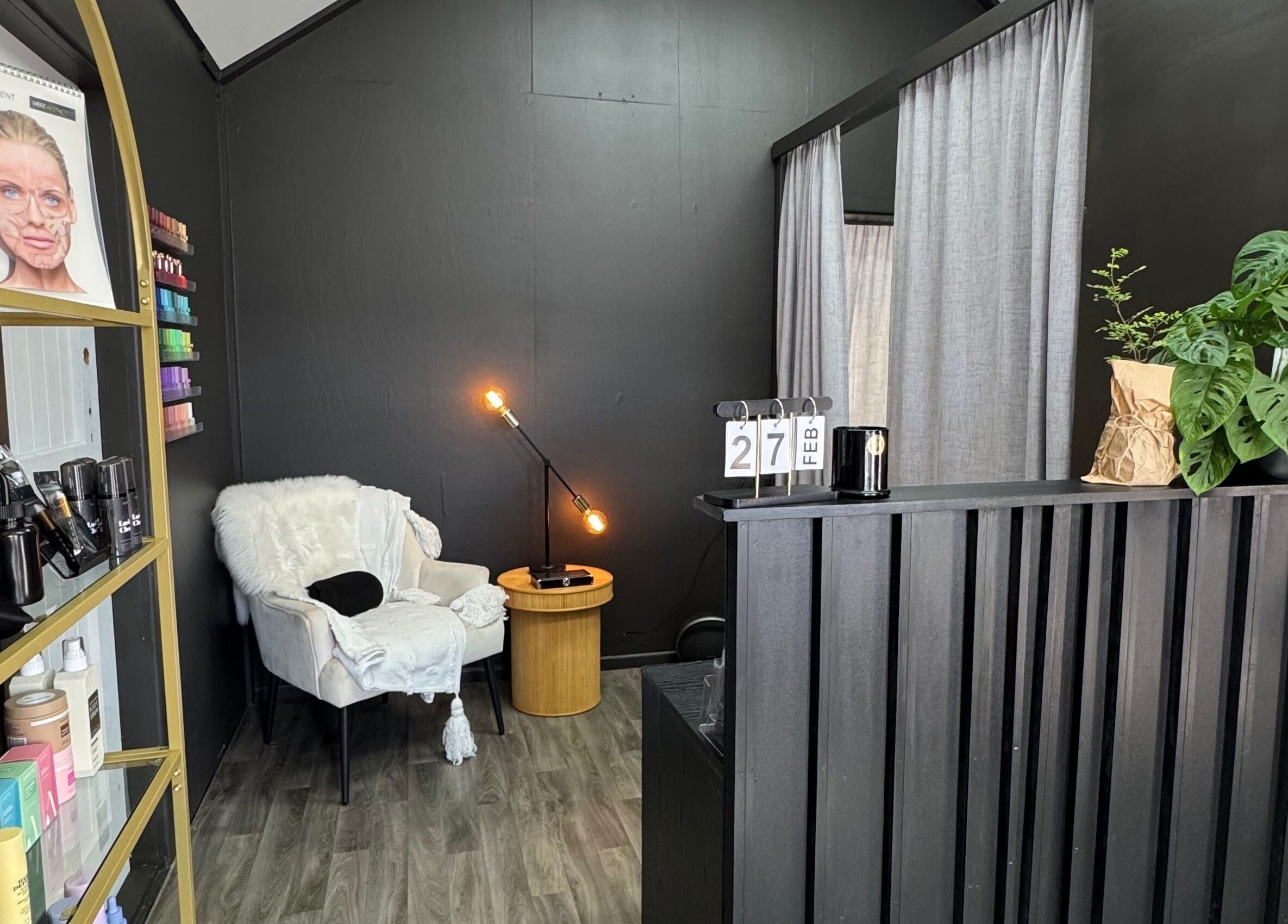 Interior of StudioEDIT in Kawakawa, Northland, NZ, showcasing a cozy chair, lamp, and beauty products.