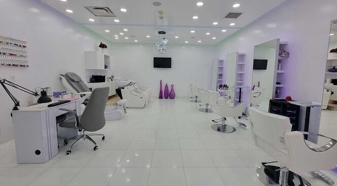 Bright, modern interior of Salon Glo Valencia in Valencia, California, featuring chic styling chairs and manicure stations.