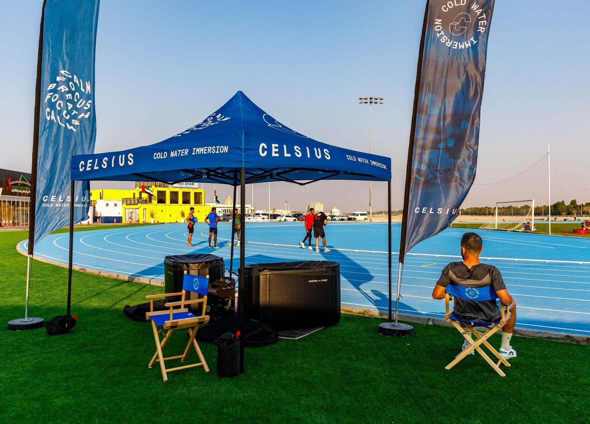 Outdoor setup at Celsius Cold Water Immersion, Abu Dhabi, AE featuring a blue track and relaxation area.