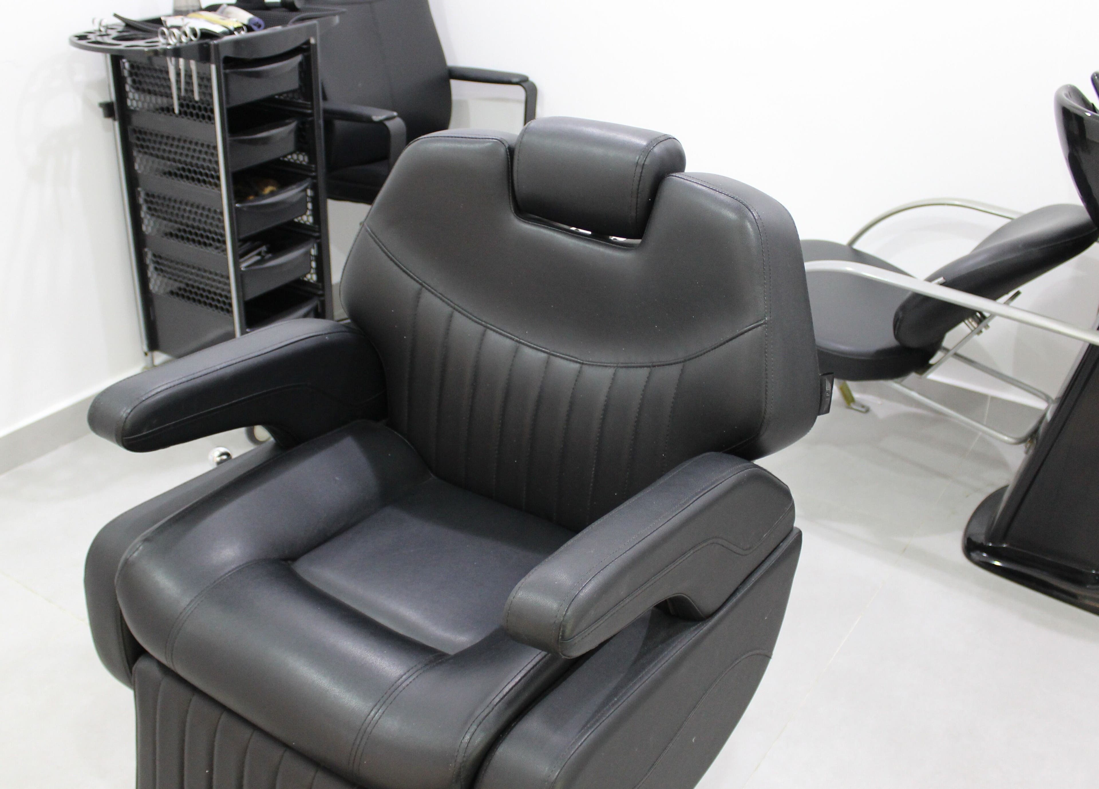 Comfortable salon chair at New Images, Dubai, 127825, AE, ready for hairstyling services.