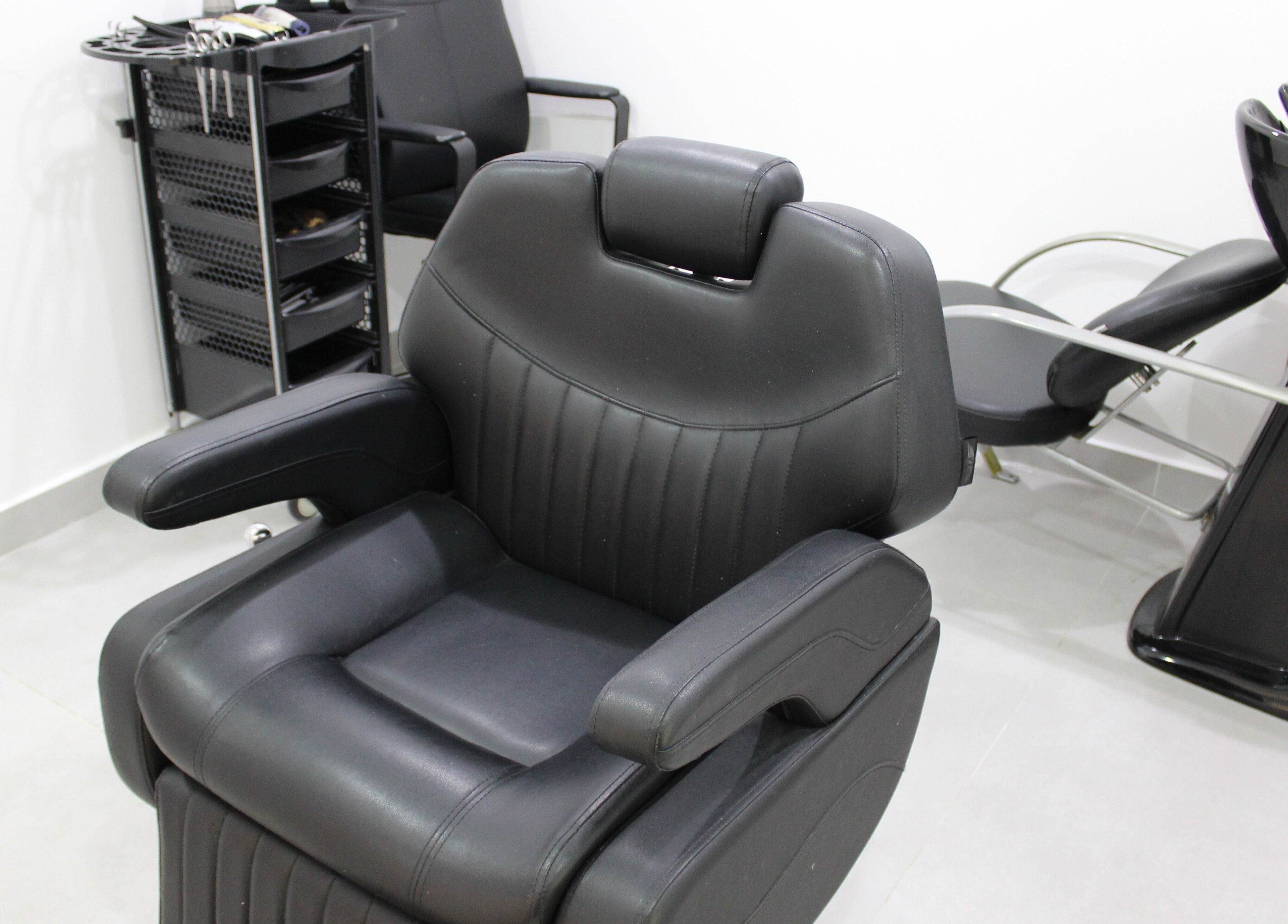 Comfortable salon chair at New Images, Dubai, 127825, AE, ready for hairstyling services.