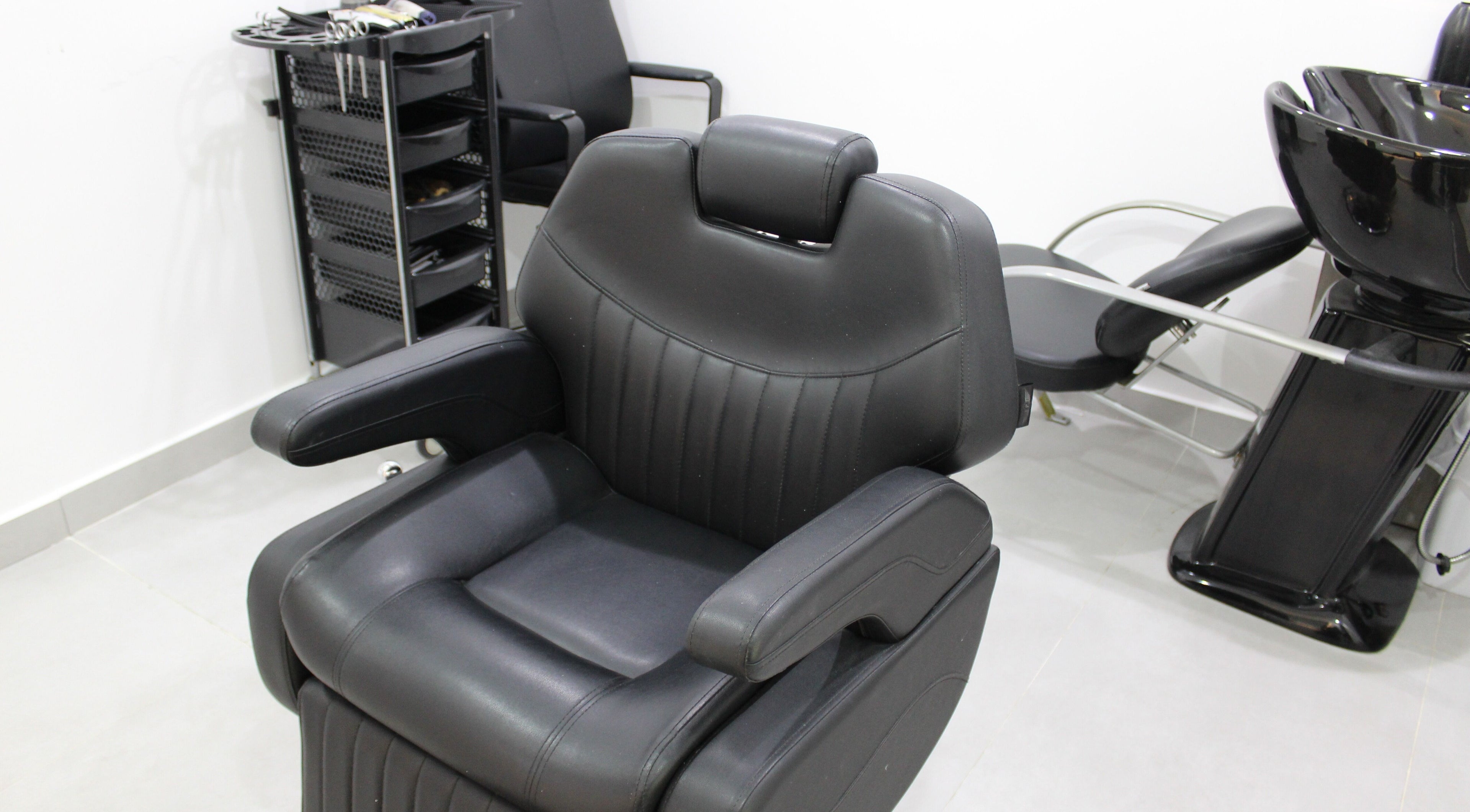 Comfortable salon chair at New Images, Dubai, 127825, AE, ready for hairstyling services.