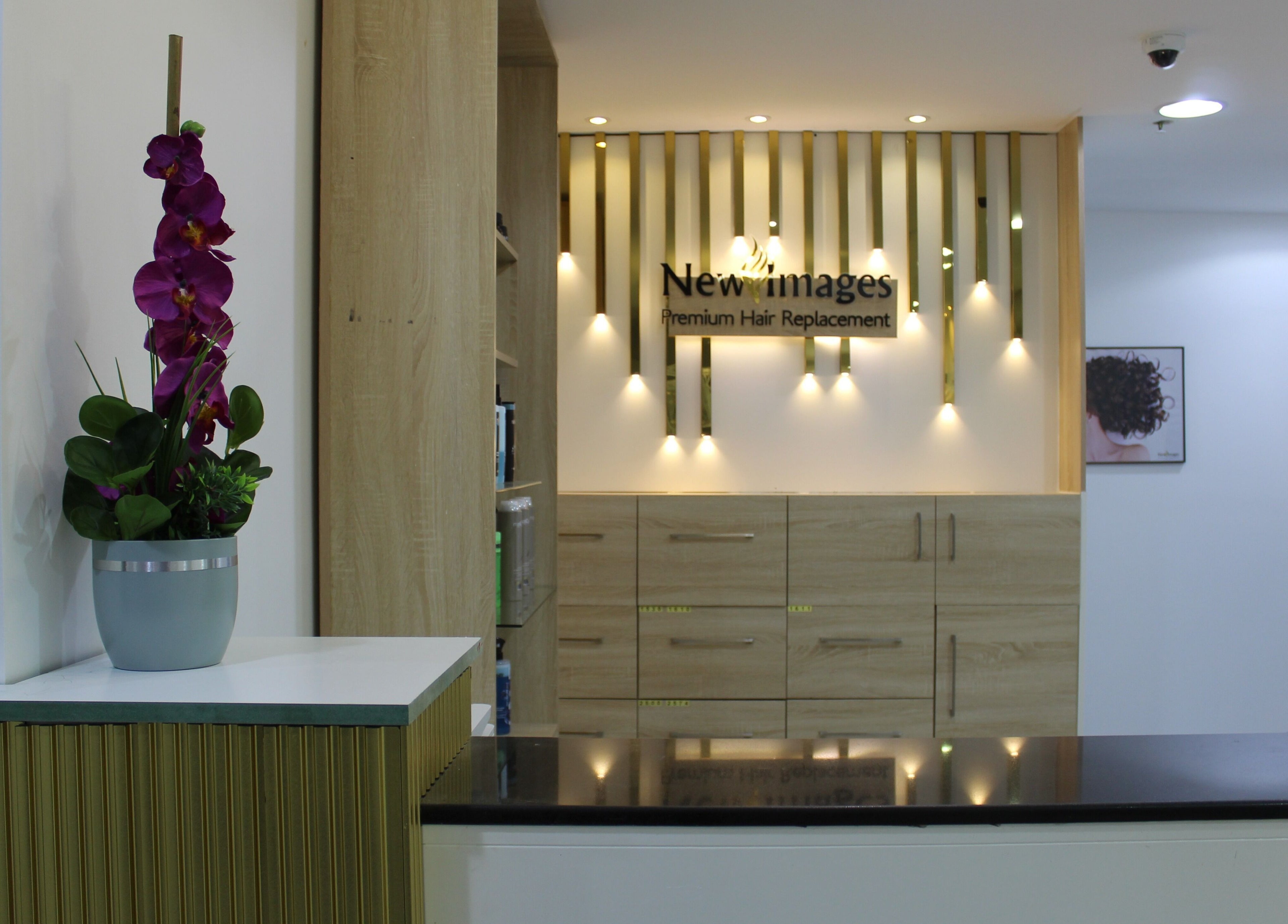 Elegant reception area at New Images, Dubai, 127825, AE, featuring modern decor and warm lighting.