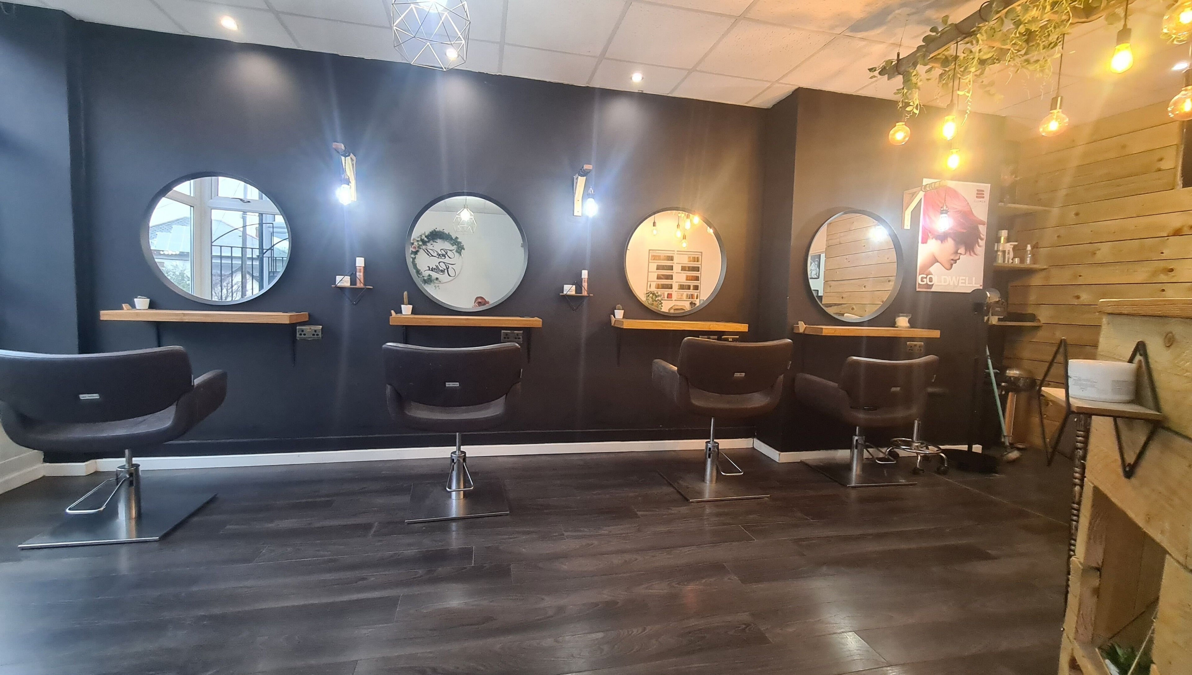 Modern salon chairs and mirrors at Rock N Rollers, Cwmfields, Wales, GB creating a stylish beauty atmosphere.