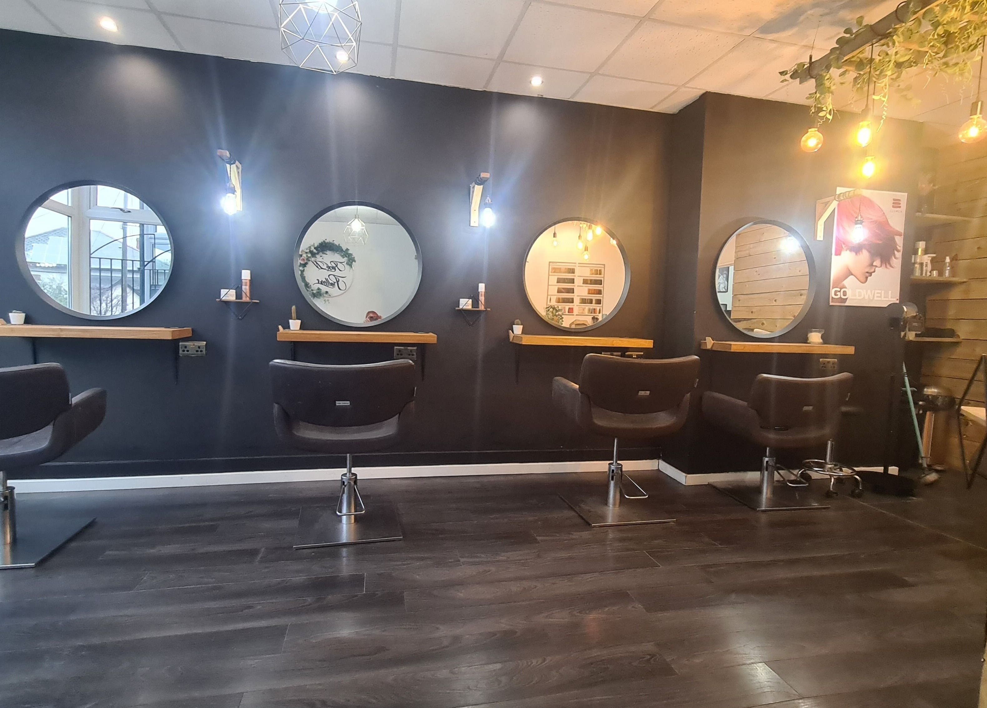 Modern salon chairs and mirrors at Rock N Rollers, Cwmfields, Wales, GB creating a stylish beauty atmosphere.