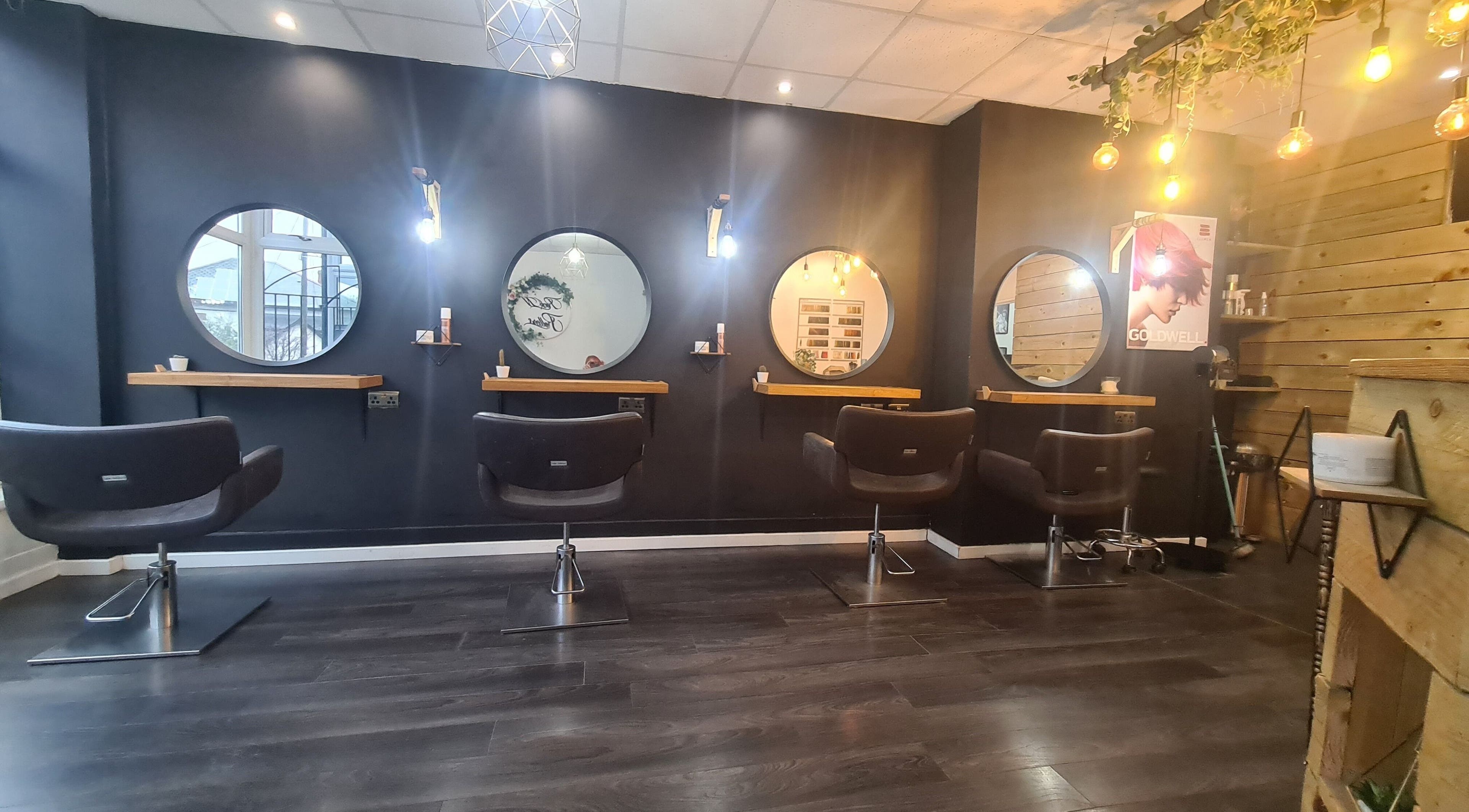 Modern salon chairs and mirrors at Rock N Rollers, Cwmfields, Wales, GB creating a stylish beauty atmosphere.