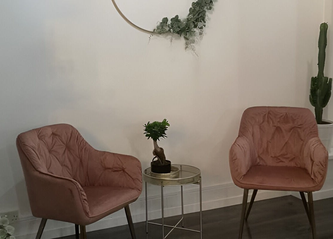 Inviting seating area at Rock N Rollers, Cwmfields, Wales, GB, featuring pink chairs and decor.