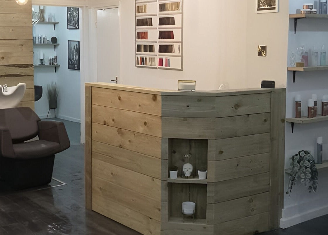 Reception area of Rock N Rollers, Cwmfields, Wales, GB. Features wooden desk, styling chairs, and product shelves.