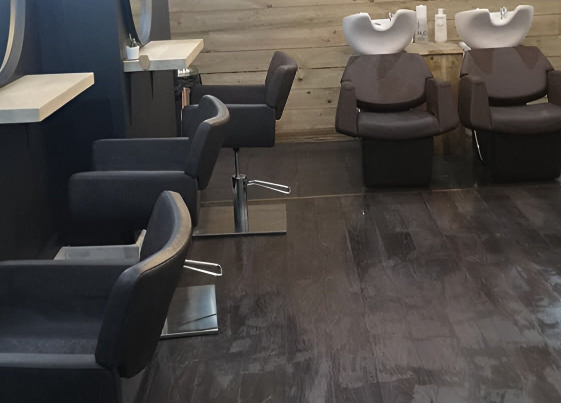 Modern salon interior at Rock N Rollers, Cwmfields, Wales, GB featuring sleek chairs and wooden decor.