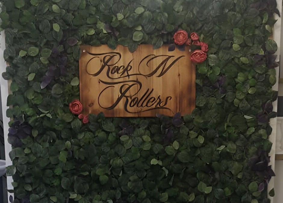 Rock N Rollers sign on a lush leafy wall at Cwmfields, Wales, GB, creating a vibrant, welcoming ambiance.