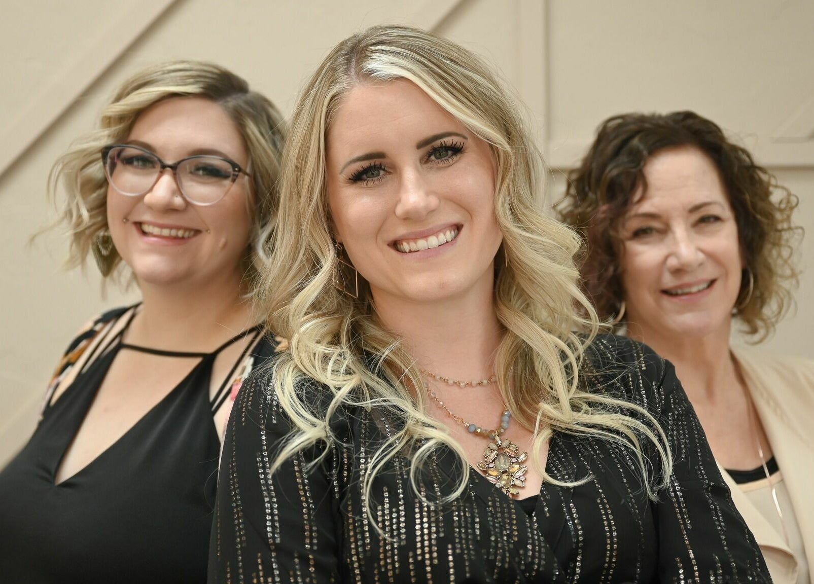 Professional team at A Borgata Salon, Prescott, Arizona. Smiling women showcasing hairstyles.