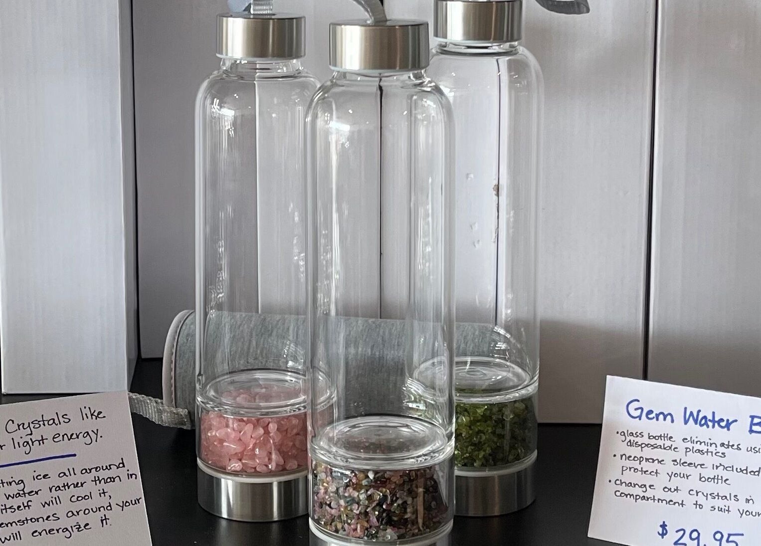 Gem water bottles with crystals at R3 Wellness in Durham, North Carolina, US, showcasing eco-friendly design.