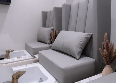 Luxurious pedicure lounge at Abby Nails Leyton in London, England, GB with plush seating and opulent decor.