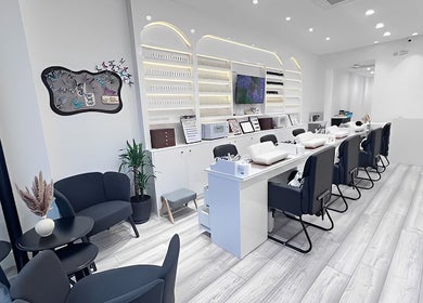 Modern interior of Abby Nails Leyton in London, England, GB featuring sleek white decor and seating.