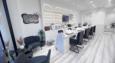 Modern interior of Abby Nails Leyton in London, England, GB featuring sleek white decor and seating.
