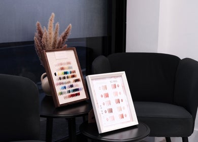 Nail polish color palettes displayed at Abby Nails Leyton, London, England, GB in a chic black seating area.