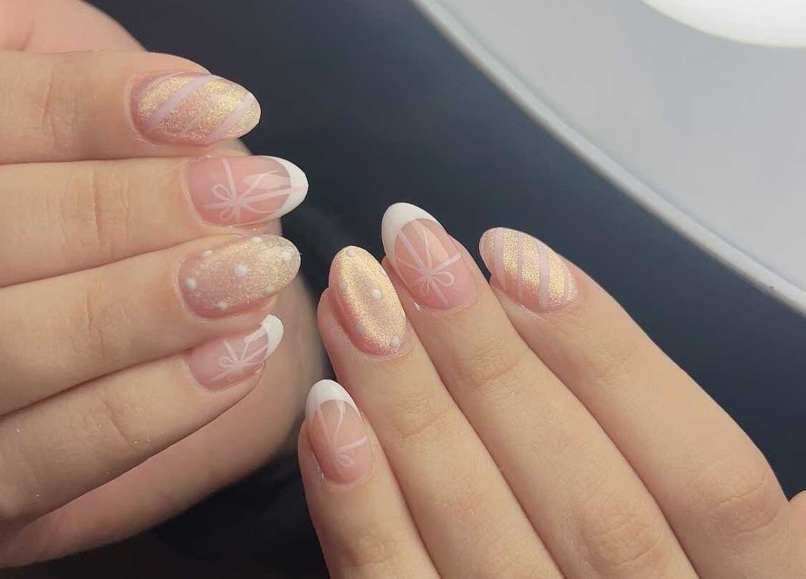 Elegant nail art at Abby Nails Finsbury Park, London, England, GB featuring shimmering designs and French tips.