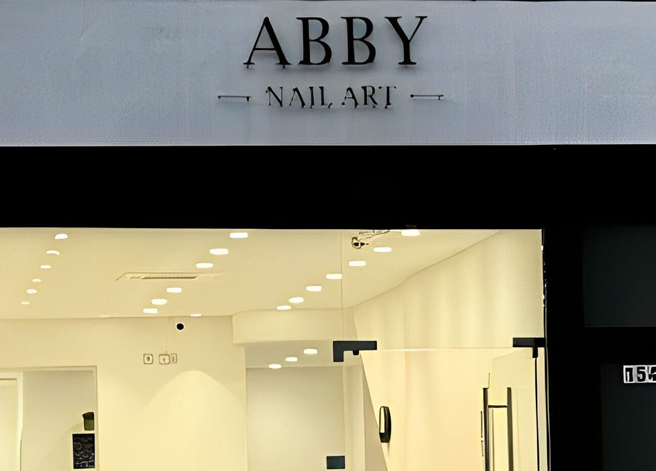 Abby Nails Leyton storefront in London, England, GB, featuring elegant lighting and sleek design.