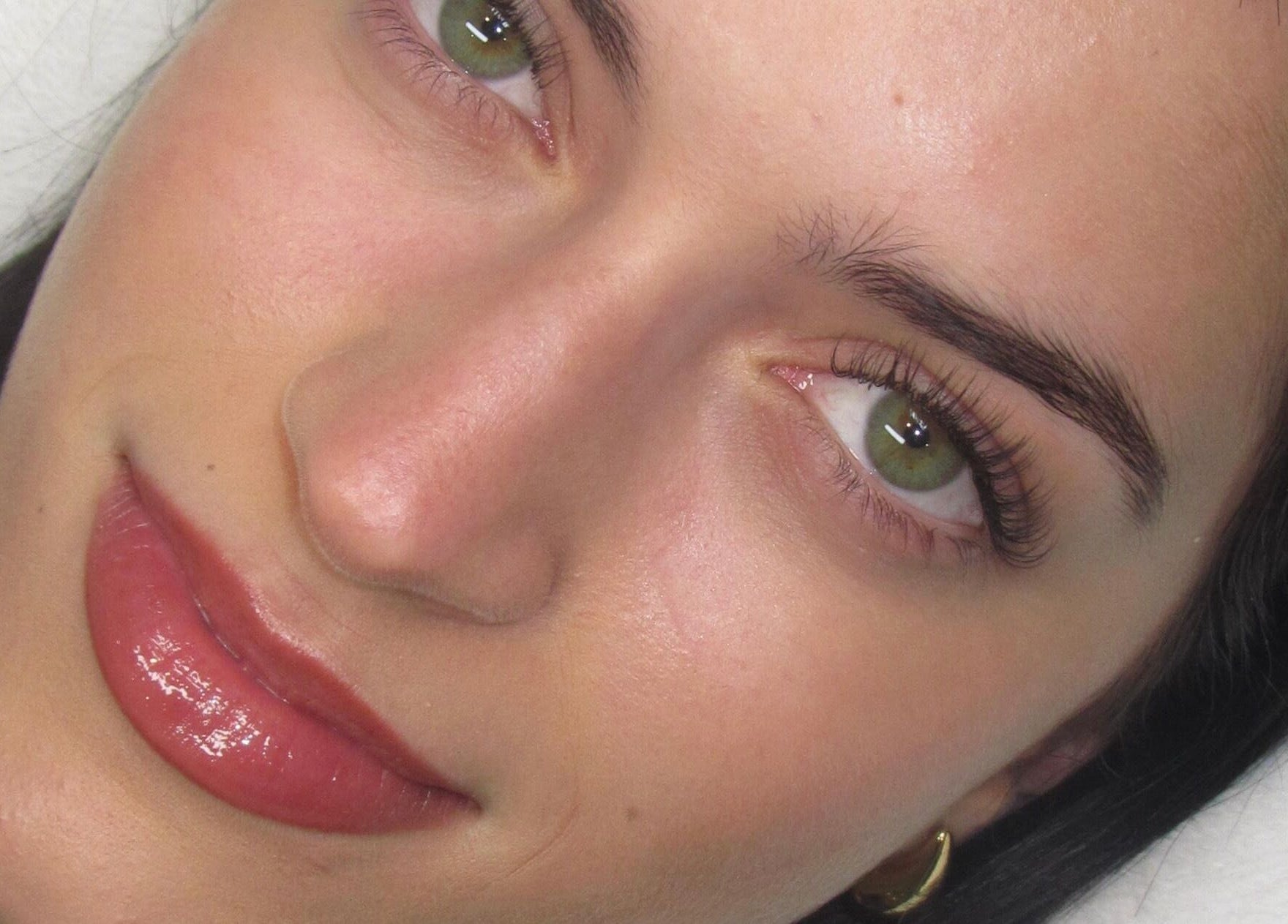 Close-up of a woman's enhanced lashes and brows at Lashesxbeautybar, Vaughan, Ontario, CA.