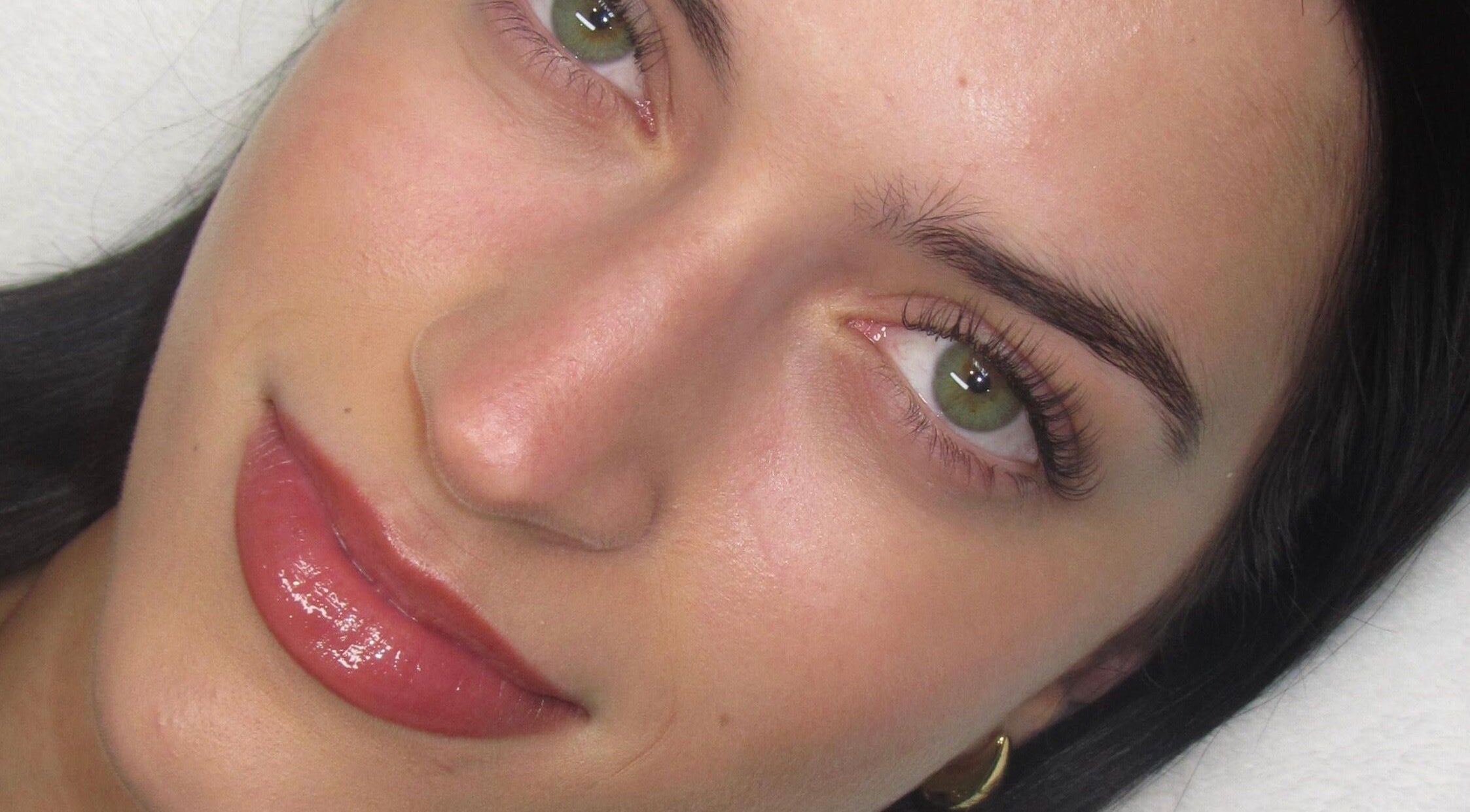 Close-up of a woman's enhanced lashes and brows at Lashesxbeautybar, Vaughan, Ontario, CA.