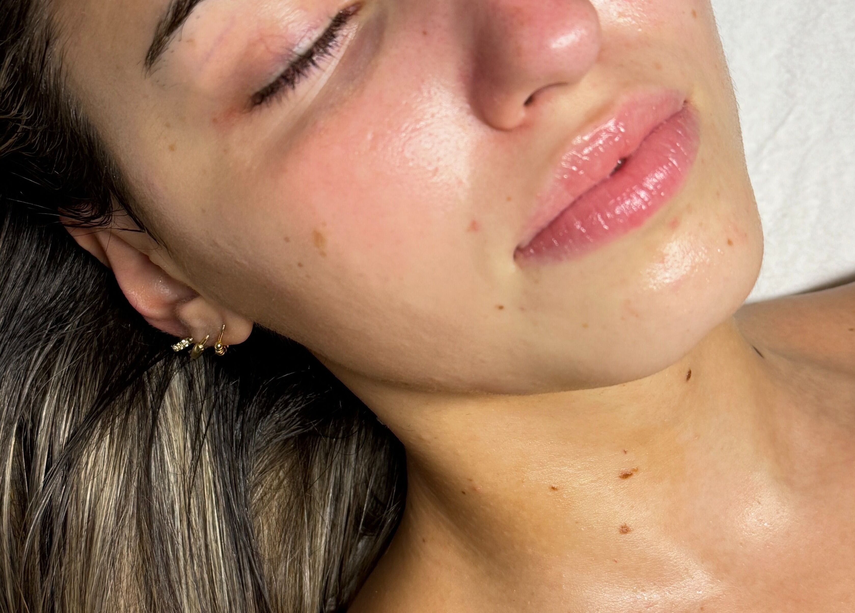 A relaxed client enjoying skincare at Lashesxbeautybar in Vaughan, Ontario, CA with glowing skin.