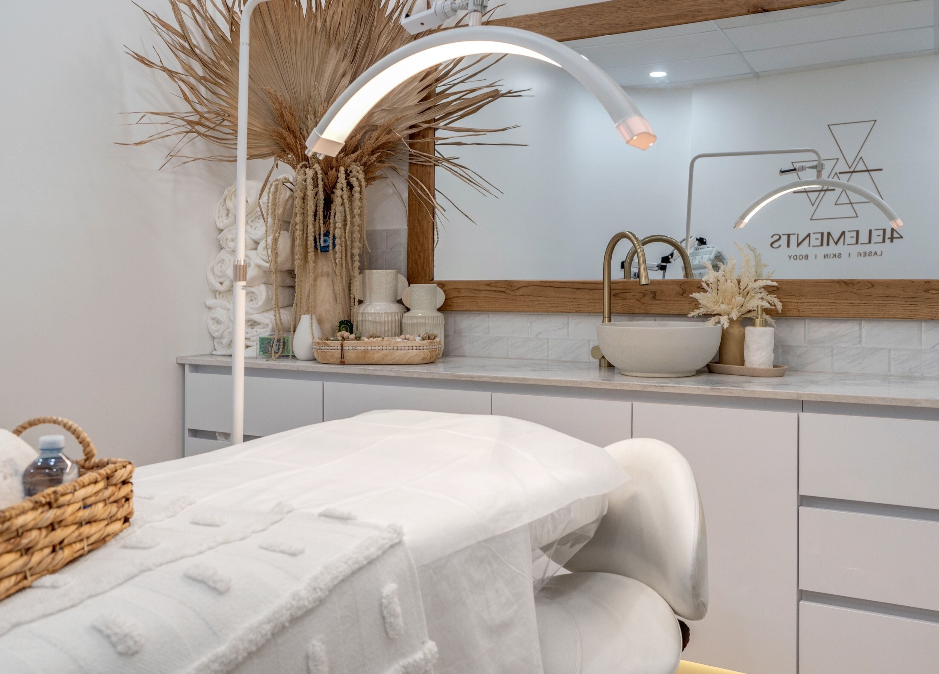 Luxurious treatment room at 4 Elements Clinic, Melbourne, Victoria, AU with elegant decor and plush bedding.