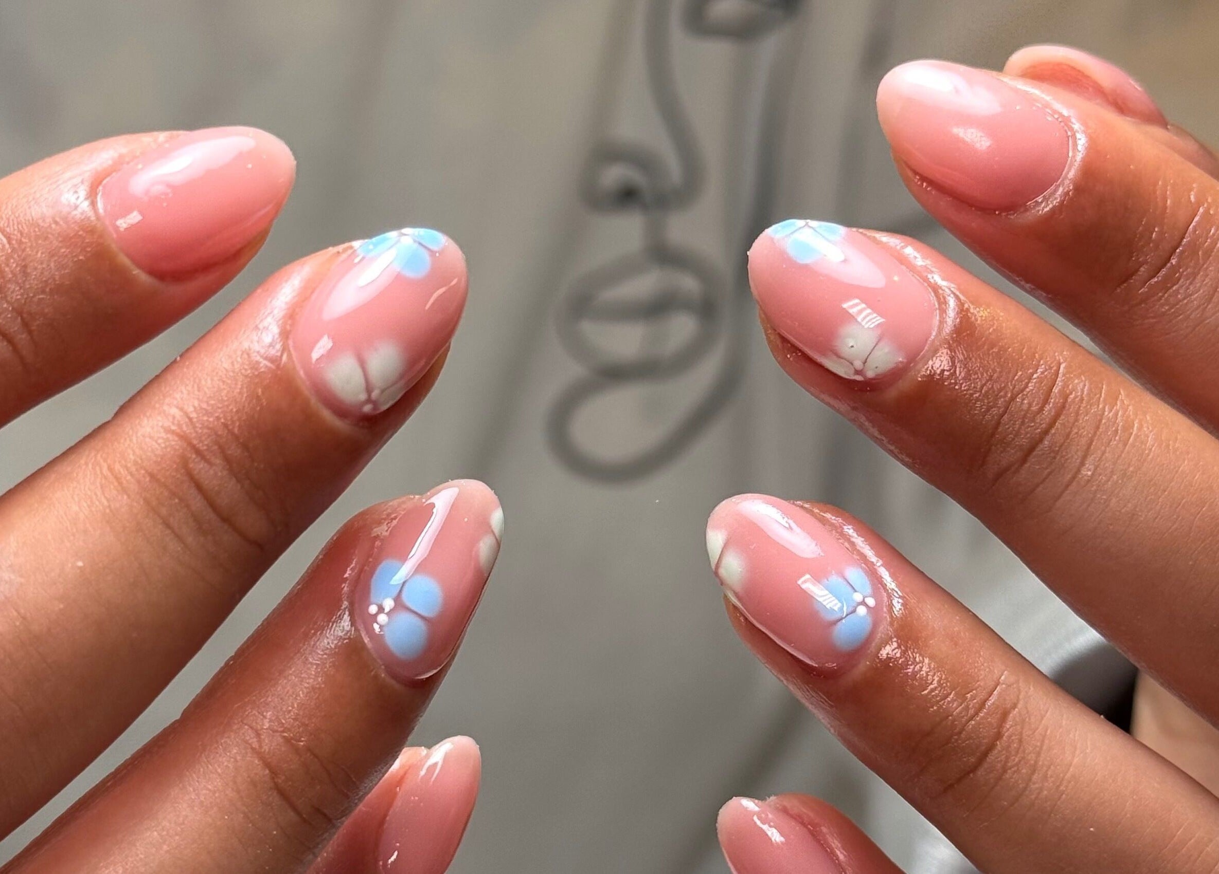 Floral nail art at Glossed by Holly, Coatbridge, Scotland, GB, showcasing elegant pink and blue designs.