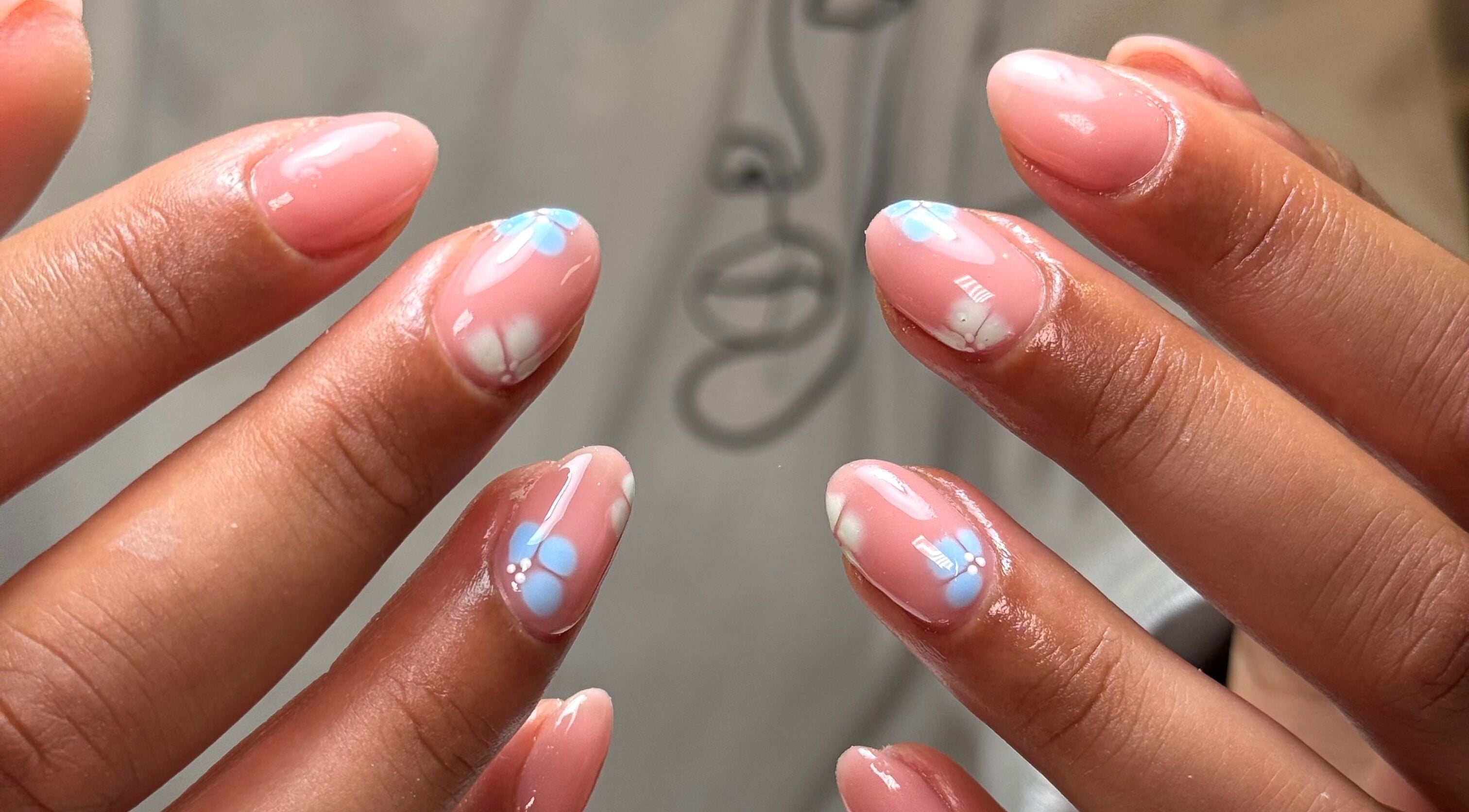 Floral nail art at Glossed by Holly, Coatbridge, Scotland, GB, showcasing elegant pink and blue designs.