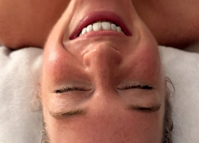 Smiling client enjoying a facial at The Skin Therapist at Skin & Wellness Alvechurch, Alvechurch, England, GB.