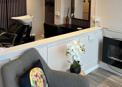 Chic interior at Bon Visage Aesthetics Ltd, Shepshed, Loughborough, England, GB, featuring a salon chair and fireplace.