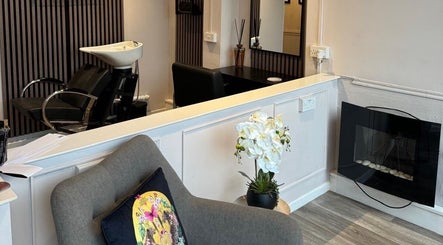 Chic interior at Bon Visage Aesthetics Ltd, Shepshed, Loughborough, England, GB, featuring a salon chair and fireplace.