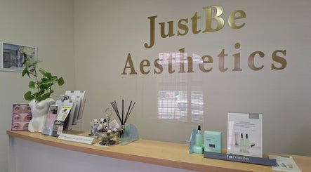 Reception at JustBe Aesthetics Skin Clinic, Cape Town, Western Cape, ZA with elegant decor and skincare products.