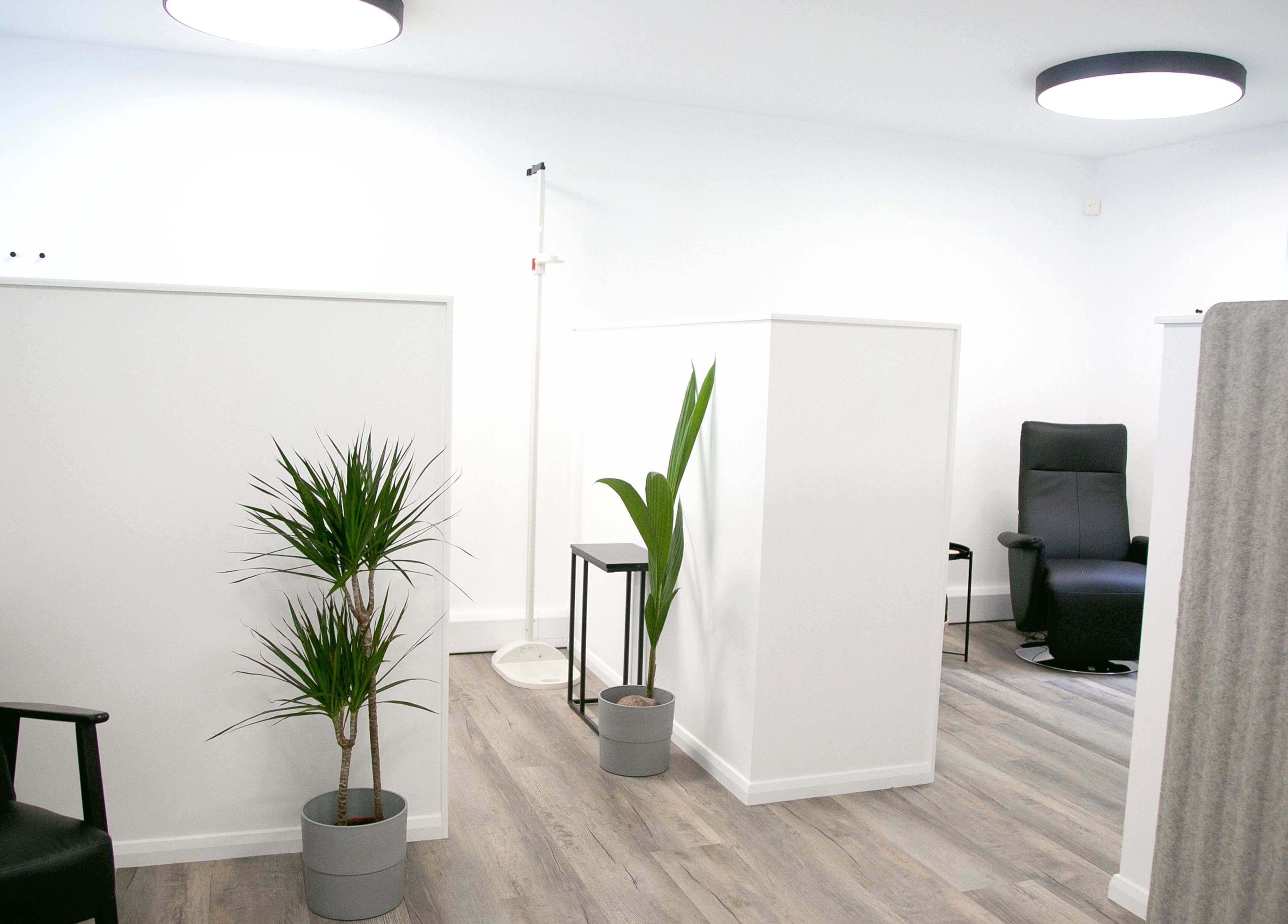 Modern relaxation space at NutriZen Wellness Centre in Wolverton, England, featuring sleek chairs and plants.