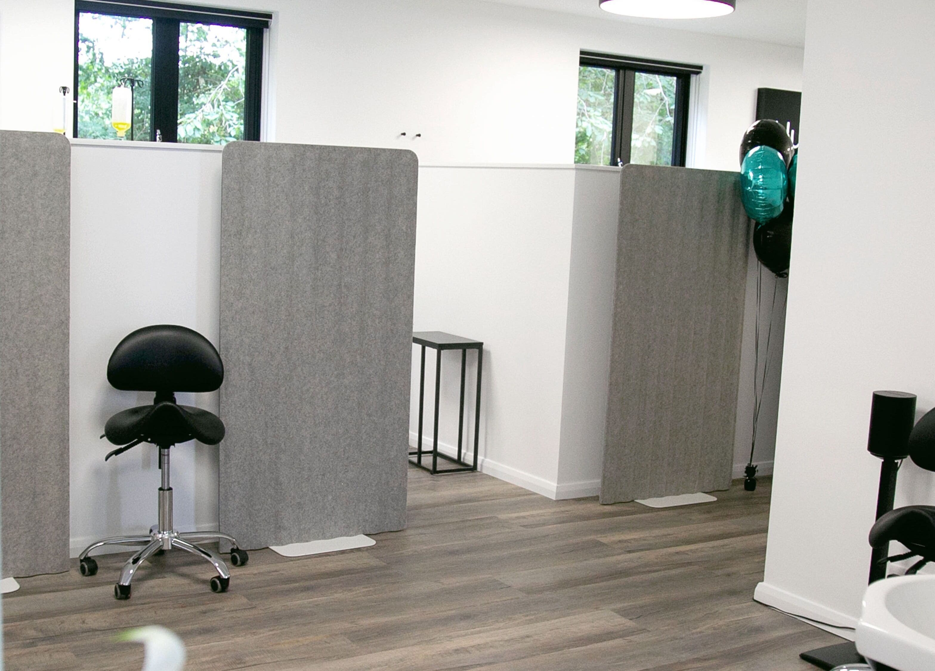 Modern treatment area at NutriZen Wellness Centre, Wolverton, England, GB, featuring minimalist design and seating.